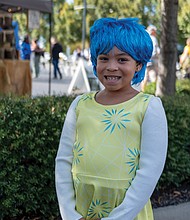 Full of joy/Eight-year-old McKinzee Adams shines at the Pumpkin Festival at Midtown Green, dressed as Joy from “Inside Out,” the 2015 animated film. (Sandra Sellars/Richmond Free Press)