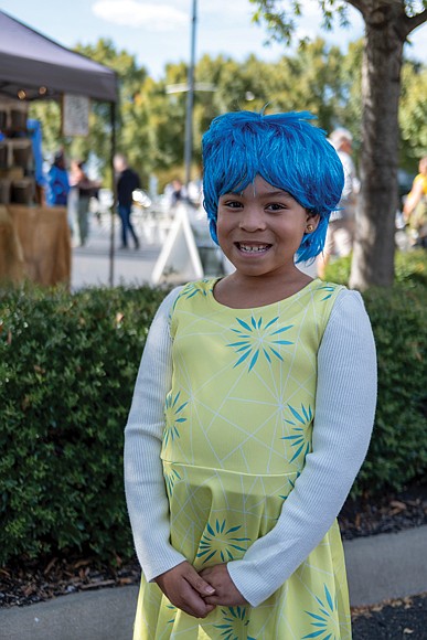 Full of joy/Eight-year-old McKinzee Adams shines at the Pumpkin Festival at Midtown Green, dressed as Joy from “Inside Out,” the 2015 animated film. (Sandra Sellars/Richmond Free Press)
