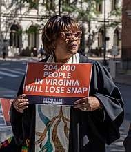 Rev. Dr. Patricia Crawley-Ricks is seen outside the
offices of U.S. Sens. Tim Kaine and Mark Warner at 919 E. Main St. in Richmond as part of a coordinated, nonviolent mass prayer action held at congressional offices across the country.