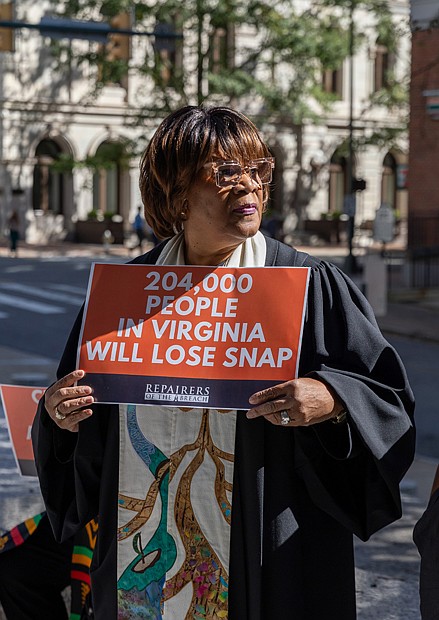 Rev. Dr. Patricia Crawley-Ricks is seen outside the
offices of U.S. Sens. Tim Kaine and Mark Warner at 919 E. Main St. in Richmond as part of a coordinated, nonviolent mass prayer action held at congressional offices across the country.