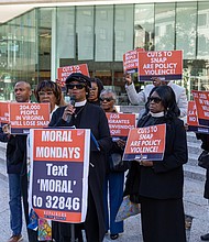 The Rev. Dr. Tonya Pass, pastor of Zion Chester AME Zion Church, is seen outside the offices of U.S. Sens. Tim Kaine and Mark Warner at 919 E. Main St. in Richmond as part of a coordinated, nonviolent mass prayer action held at congressional offices across the country. To her left is the Rev. Dr. Patricia Crawley-Ricks and to her far left is the Rev. Billy Cook, an Army veteran. To her far right is the Rev. Alma Coles Charles, pastor of St. Paul AME Zion Church.