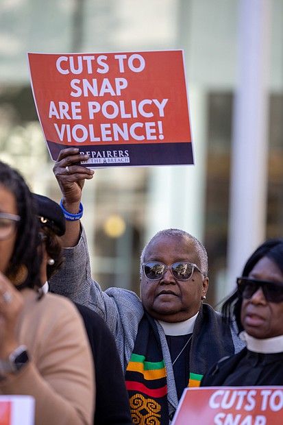 Dozens of Virginians, including clergy and community leaders are seen outside the offices of U.S. Sens. Tim Kaine and Mark Warner at 919 E. Main St. in Richmond as part of a coordinated, nonviolent mass prayer action held at congressional offices across the
country.