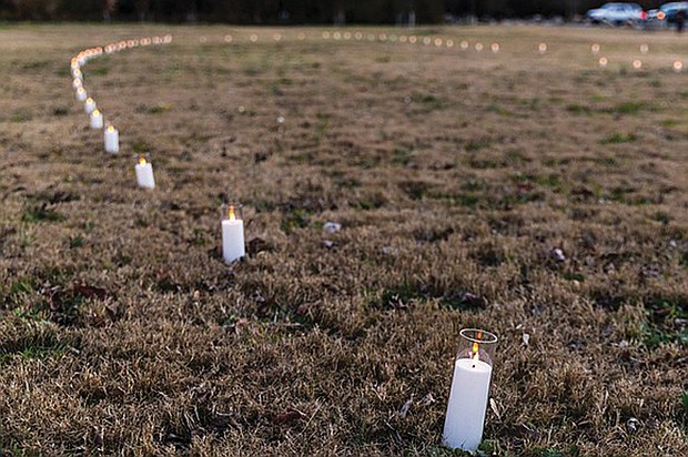 Battery-powered candles marked the future site of a 12-foot bronze sculpture commemorating the arrival point of enslaved people on the banks of the James River during the Shockoe Project Celebration at Ancarrow’s Landing in 2024.