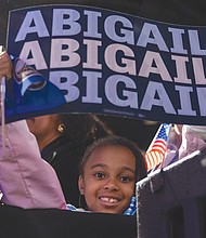 A young supporter listens to Abigail Spanberger’s acceptance speech after she was elected Virginia’s first female governor.