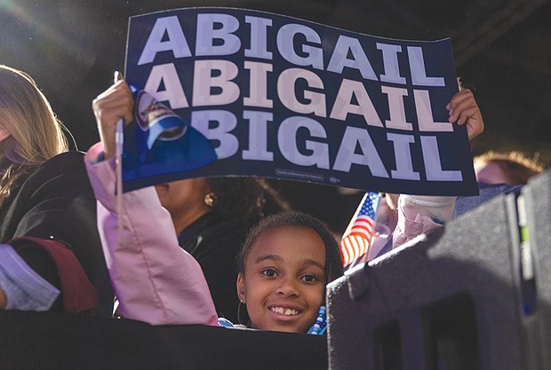 A young supporter listens to Abigail Spanberger’s acceptance speech after she was elected Virginia’s first female governor.