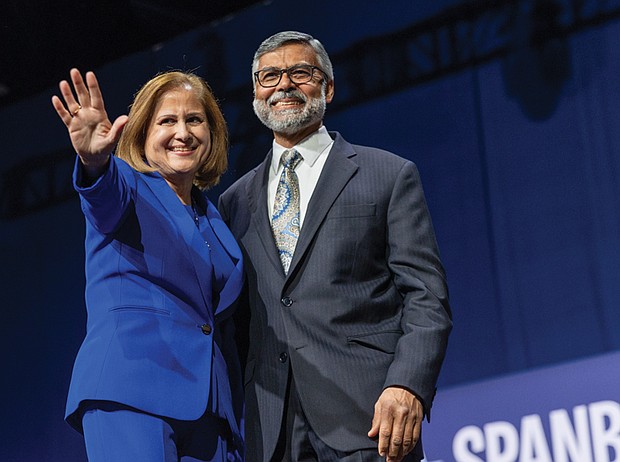 Sen. Ghazala Hashmi, with her husband, Azhar Rafiq, waves to supporters after being elected Virginia’s next lieutenant governor.