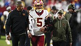 Washington Commanders quarterback Jayden Daniels (5) is helped off
the field after injuring his arm on Sunday in the second half of an NFL
football game against the Seattle Seahawks in Landover, Md.