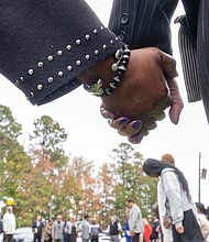 Groundbreaking ceremony commemorates Brown Grove School-The Brown Grove School Memorial Committee held a groundbreaking ceremony Oct. 26 for a new memorial across from Brown Grove Baptist Church in Ashland. The memorial honors the historic Brown Grove School, a two-room schoolhouse built in 1925 that educated African American children in grades 1–7 until it was destroyed by fire in 1942. The school served as a center of learning, pride, and resilience for the Brown Grove community. Attendees hold hands during the groundbreaking ceremony for the Brown Grove School Memorial,
designed in part by civil engineer Fyiad Constantine to symbolize the original two-room schoolhouse.(Sandra Sellars/Richmond Free Press)