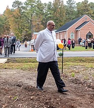 Groundbreaking ceremony commemorates Brown Grove School-The Brown Grove School Memorial Committee held a groundbreaking ceremony Oct. 26 for a new memorial across from Brown Grove Baptist Church in Ashland. The memorial honors the historic Brown Grove School, a two-room schoolhouse built in 1925 that educated African American children in grades 1–7 until it was destroyed by fire in 1942. The school served as a center of learning, pride, and resilience for the Brown Grove community. The Rev. Darius Beecham, pastor of The Historic Brown Grove Baptist Church leads church and community members across the street for the groundbreaking.(Sandra Sellars/Richmond Free Press)