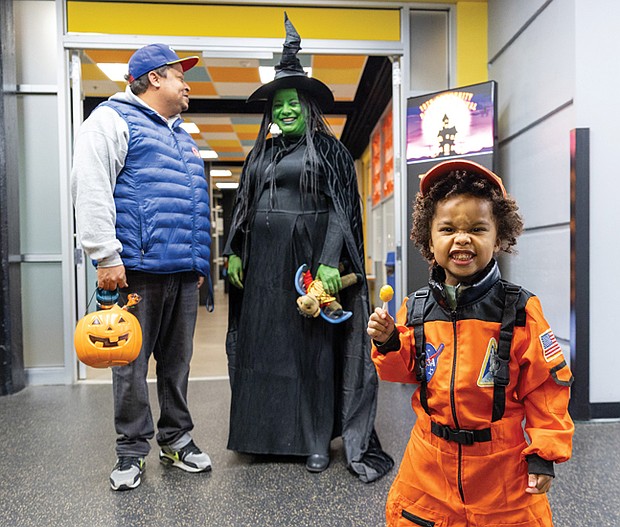 Halloween blasts off-Bryson Fischer Wesley, 4, suits up as an astronaut for Halloween on Friday during U.S. Rep. Jennifer McClellan’s annual Community Harvest Festival at the Science Museum of Virginia. The festival offered Richmond-area children a chance to trick-or-treat and explore museum exhibits and activities throughout the evening. (Julianne Tripp Hillian)