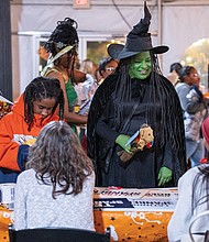 Tricks, treats and togetherness-Families flocked to the Science Museum of Virginia on Halloween for U.S. Rep. Jennifer McClellan’s annual Community Harvest Festival. U.S. Rep. Jennifer McClellan, dressed as the
Wicked Witch, greets families during her annual Community Harvest Festival on Halloween. The event, held Friday evening, offered Richmond-area children a safe space to trick-or-treat, enjoy museum exhibits and connect with community resources. Guests explored hands-on experiences in the museum’s Speed, Boost and The Power of Poison exhibits, along with its Animal, Art and Eco Labs. Halloween laser shows and live science demos added to the night’s festivities. (Julianne Tripp Hillian/Richmond Free Press)