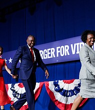 Virginia House Speaker Don Scott Jr., D-Portsmouth, walks off the stage with his wife, Mellanda Colson Scott, and their daughter after delivering his victory speech Tuesday, Nov. 4.