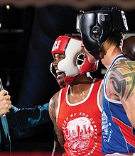 Police, firefighters duke it out for charity-Keivon Henderson of the Richmond City Firefighters shares a post-fight moment with Richmond Police’s Duane Peppel — and the announcer — after their bout. Henderson claimed the win for the firefighters in the charity showdown. Richmond City firefighters and police officers traded gloves for a good cause during River City Fight Night: Red Fight & Blue at River City Roll on Nov. 5. The charity boxing event raised funds for the Children’s Hospital Foundation, selected by the Fire Department, and the American Kidney Fund, chosen by the Police Department. (Julianne Tripp Hillian/Richmond Free Press)