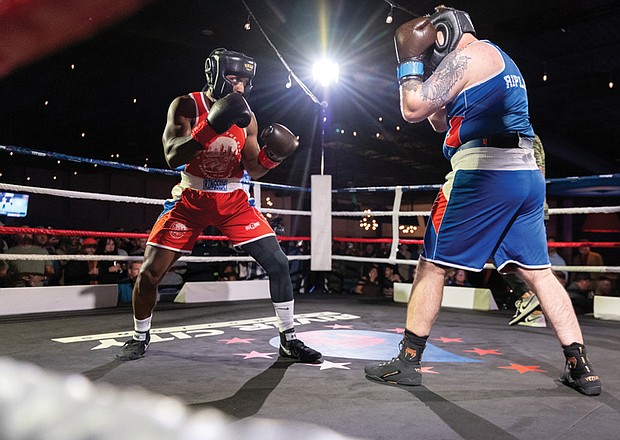Police, firefighters duke it out for charity-Mo’Reese Moore, representing Richmond firefighters, squares off against Patrick Ripley of Richmond police. Richmond City firefighters and police officers traded gloves for a good cause during River City Fight Night: Red Fight & Blue at River City Roll on Nov. 5. The charity boxing event raised funds for the Children’s Hospital Foundation, selected by the Fire Department, and the American Kidney Fund, chosen by the Police Department. (Julianne Tripp Hillian/Richmond Free Press)