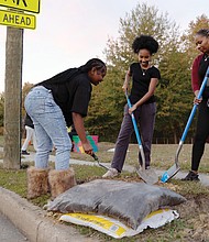 Cityscape Slices of life and scenes in Richmond- Aqiyla McMillan of RVA Rapid Transit, her daughter Kayden McMillan and her goddaughter Kasey Collins planted trees Wednesday, Nov. 12, at the bus stop at Fairfield Avenue and Kane Street as part of Richmond Tree Week. A recent inventory found that 36% of the city’s tree wells are empty, leaving about 44,000 missing trees. Environmental data analyst Melanie Del Pozo reported that 403 bus stops have at least one vacant tree well and 227 have none. Many are in neighborhoods where residents face higher heat exposure. Richmond Tree Week, held Nov. 1-8, included more than 30 free events. Activities featured volunteer plantings, tree giveaways, walking and biking tours and educational workshops. (Julianne Tripp Hillian/Richmond Free Press)