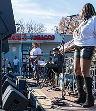 Neighborhood pride shines at Brookland Park Fest-Brookland Park Fest filled the boulevard with music, art and food as residents and visitors gathered Sunday, Nov. 9 for the annual community celebration. The free event, organized by the Brookland Park Business Association, showcased local businesses, artists and food vendors, along with musical performances, family activities and special events hosted by shops along Brookland Park Boulevard between Fendall and North avenues. ShaMecca “Mecca” and LaTeshia “Teshia” LeSane, owners of the Harlym
Blue’Z restaurant in Brookland Park, perform during the festival. (Julianne Tripp Hillian)