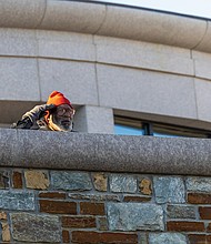 Paying tribute-The ceremonies honored Virginians who have served and those currently serving in the U.S. Armed Forces. Remmie Chew Jr., a Marine veteran who served 16 years, salutes. (Julianne Tripp Hillian/Richmond Free Press)