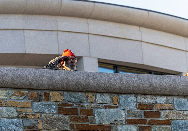 Paying tribute-The ceremonies honored Virginians who have served and those currently serving in the U.S. Armed Forces. Remmie Chew Jr., a Marine veteran who served 16 years, salutes. (Julianne Tripp Hillian/Richmond Free Press)