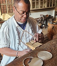 Preston Jones, senior journeyman silversmith, works on crafting the Commonwealth Prize medal.