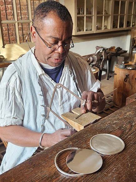 Preston Jones, senior journeyman silversmith, works on crafting the Commonwealth Prize medal.