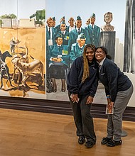 ‘Giants’ excitement-Alicia Keys and Swizz Beatz were welcomed by cheering Richmond-area high school and
college students during a pep rally for the “Giants” exhibition at the Virginia Museum of Fine Arts on Wednesday, Nov. 19. The couple were greeted to the stage by the All-City RPS Drum Line and answered questions about their careers as musical artists. Nevaeh Coles, left, and Ro’miah Short, 9th graders at Cristo Rey Richmond High School, pose together at the exhibition. The students attended the morning pep rally where Alicia
Keys and Swizz Beatz made a surprise appearance.(Julianne Tripp Hillian/Richmond Free Press)