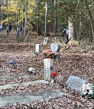 Volunteers from area churches and organizations help reclaim Old St. John’s Cemetery in Kilmarnock during a Nov. 15 cleanup.
