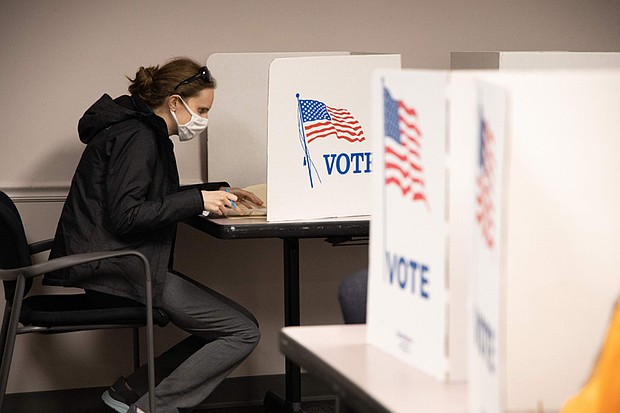 A voter casts a ballot at the Fairfax County Government Center in 2020.