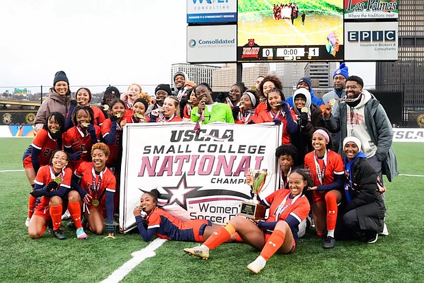 Virginia State women’s soccer players celebrate on the field after their 1–0 win over Shaw University to claim the USCAA Division I national championship.