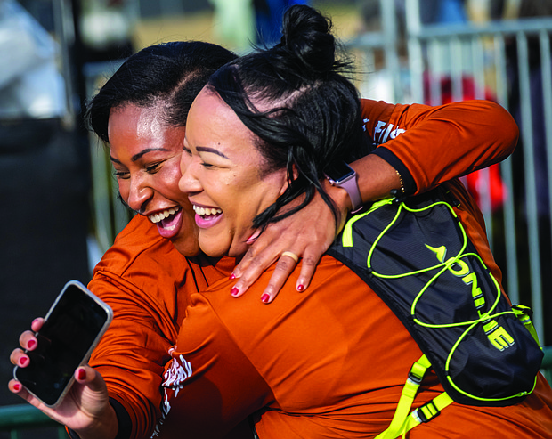 Finishing strong-About 21,000 runners took part in the 48th Allianz Richmond Marathon, known as America’s friendliest marathon. Crowds lined the streets, bands played along the course, and volunteers cheered runners on as they made their way to the iconic downhill finish. Sadhari Cowan and Blair Jeffress celebrate after reaching the finish line of the 8K. (Photo by Sandra Sellars/Richmond Free Press)