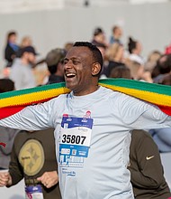 Finishing strong-About 21,000 runners took part in the 48th Allianz Richmond Marathon, known as America’s friendliest marathon. Crowds lined the streets, bands played along the course, and volunteers cheered runners on as they made their way to the iconic downhill finish. Yftahe Gebru smiles after crossing the finish line of the 8K at the marathon
event. (Photo by Sandra Sellars/Richmond Free Press)