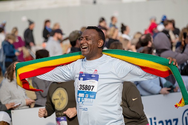 Finishing strong-About 21,000 runners took part in the 48th Allianz Richmond Marathon, known as America’s friendliest marathon. Crowds lined the streets, bands played along the course, and volunteers cheered runners on as they made their way to the iconic downhill finish. Yftahe Gebru smiles after crossing the finish line of the 8K at the marathon
event. (Photo by Sandra Sellars/Richmond Free Press)