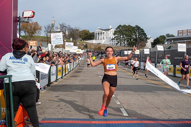 Finishing strong-About 21,000 runners took part in the 48th Allianz Richmond Marathon, known as America’s friendliest marathon. Crowds lined the streets, bands played along the course, and volunteers cheered runners on as they made their way to the iconic downhill finish. Casey Mulroy crosses the finish line first among women at the 2025 Allianz Richmond Marathon with a victorious smile. (Photo by Sandra Sellars/Richmond Free Press)