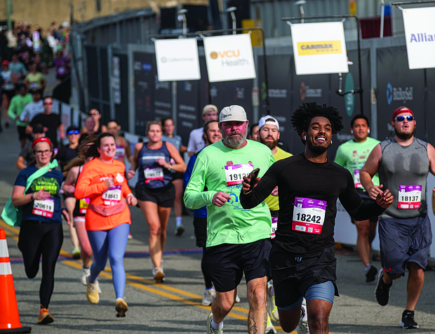 Finishing strong-About 21,000 runners took part in the 48th Allianz Richmond Marathon, known as America’s friendliest marathon. Crowds lined the streets, bands played along the course, and volunteers cheered runners on as they made their way to the iconic downhill finish. (Photo by Sandra Sellars/Richmond Free Press)