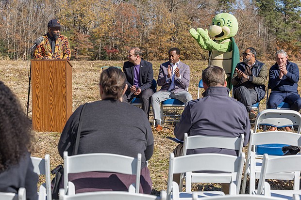 Cityscape Slices of life and scenes in Richmond-Duron Chavis, executive director of Happily Natural Day, speaks during the announcement of a new Henrico community farm at the Runnymeade property off Willis Church Road on Monday, Nov. 17, as Stewart, the mascot of Henrico’s Environmental Action Resource Team, looks on. Seated are John Zannino, Henrico Division of Recreation and Parks director; Tyrone Nelson, Varina District supervisor; Stewart; Roscoe D. Cooper III, Fairfield District supervisor; and John Vithoulkas, Henrico County manager. The farm will begin with 10 acres in a pilot phase managed by the nonprofit, with potential to expand based on community interest. Farmers may apply for quarter- or half-acre plots in late fall.