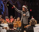 Conductor Hae Lee leads the Richmond Symphony during the “Let It Snow” holiday program at the Carpenter Theatre.