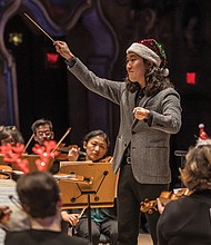Conductor Hae Lee leads the Richmond Symphony during the “Let It Snow” holiday program at the Carpenter Theatre.