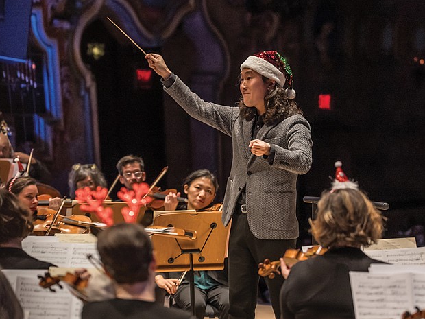 Conductor Hae Lee leads the Richmond Symphony during the “Let It Snow” holiday program at the Carpenter Theatre.