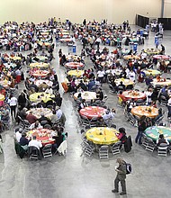 Guests gather for a community meal during The Giving Heart’s Thanksgiving Day Feast at the Greater Richmond Convention Center in 2019. The Richmond nonprofit will host its 20th annual feast on Thursday, offering free meals, flu shots and essential items from 10 a.m. to 2 p.m.