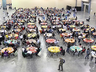 Guests gather for a community meal during The Giving Heart’s Thanksgiving Day Feast at the Greater Richmond Convention Center in 2019. The Richmond nonprofit will host its 20th annual feast on Thursday, offering free meals, flu shots and essential items from 10 a.m. to 2 p.m.