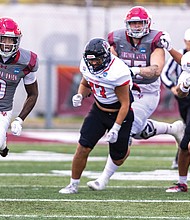 Virginia Union University’s Curtis Allen (0) fights for yardage as the Panthers fall 27-24 to California (PA) in NCAA Division II playoff action on Nov. 22.
