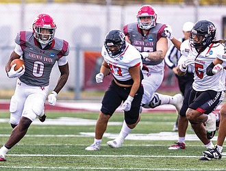 Virginia Union University’s Curtis Allen (0) fights for yardage as the Panthers fall 27-24 to California (PA) in NCAA Division II playoff action on Nov. 22.