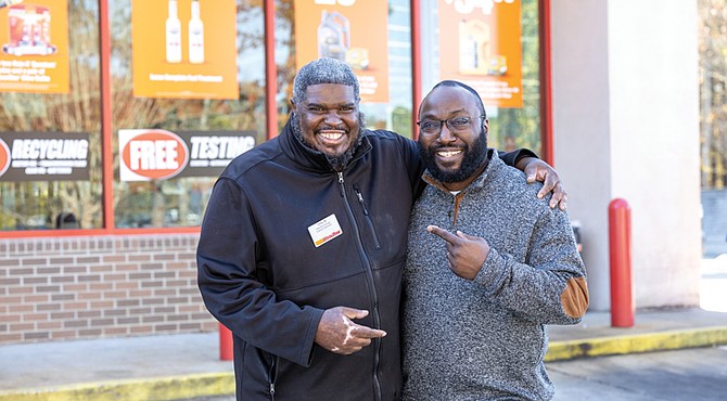 Tony Williams, left, and William Minor stand outside the AutoZone on Hull Street, where Williams works, on Nov. 13. The two recently reconnected at
the store decades after Williams helped Minor at the scene of a car crash — an act Minor says likely saved his life.