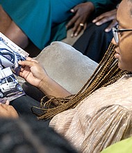 Olivia Minor looks over old photos of the car her father, William Minor, was driving when he survived a life-threatening crash decades ago.