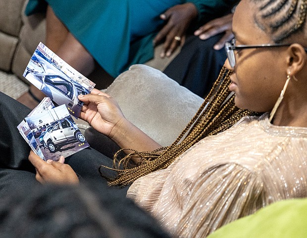 Olivia Minor looks over old photos of the car her father, William Minor, was driving when he survived a life-threatening crash decades ago.