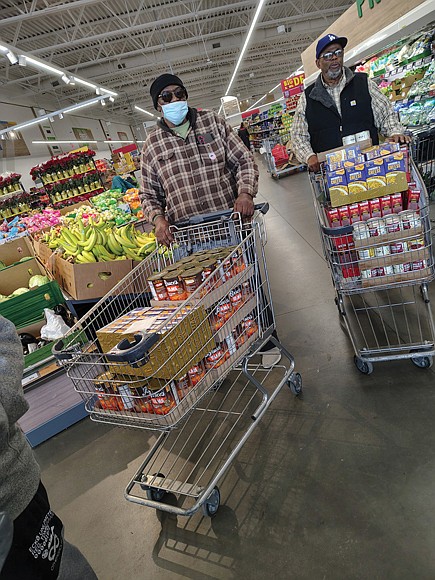 Hands and hearts at work as families receive holiday meal-Members of the Bethlehem Baptist Church men’s fellowship group shop for turkeys and groceries to fill meal boxes.(photo by Sean Taylor)