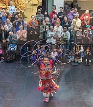 Powwow Day brings traditional dance and song-The Tsenacommacah Intertribal Dance Group wowed audiences with traditional dances, while the LoneEagle Singers filled the Virginia Museum of Fine Arts with song and dance during Family Powwow Day, presented by the Pocahontas Reframed Film Festival, on Saturday, Nov. 22. Moontree Sinquah captivates a large crowd with a hoop dance in the museum’s atrium. (photo by Julianne Tripp Hillian/Richmond Free Press)