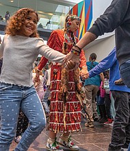 Powwow Day brings traditional dance and song-The Tsenacommacah Intertribal Dance Group wowed audiences with traditional dances, while the LoneEagle Singers filled the Virginia Museum of Fine Arts with song and dance during Family Powwow Day, presented by the Pocahontas Reframed Film Festival, on Saturday, Nov. 22. Zahara Smith, 6 (front center), joins other volunteers from the crowd for a traditional group dance with the Tsenacommacah Intertribal Dance Group. (photo by Julianne Tripp Hillian/Richmond Free Press)