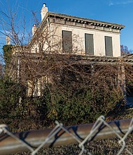 Cityscape Slices of life and scenes in Richmond-The 140-year-old Thirteen Acres School building stands behind Linwood Holton Elementary in the Hermitage Road Historic District. Built around 1885 as a brick farmhouse and later used by Richmond Public Schools for special education and office space, the structure has been vacant for nearly 20 years and is deteriorating. A School Board committee has recommended a one-year window for community proposals before demolition is considered. (photo by Julianne Tripp Hillian/Richmond Free Press)