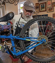 Earning two wheels Richmond Public Schools teamed up with Rag & Bones on Nov. 24 to refurbish up to 50 bikes for students who improve their attendance — with some two-wheelers rolling out to recipients as early as next week. The attendance incentive program targets students in grades K-12, though organizers expect middle and high schoolers to benefit most since they can ride to school on their own. The school district plans to distribute bikes through the spring and again before summer break. Volunteer Steven Sullivan helps repair bikes at Rag & Bones in North Side on Sunday. (photo by Julianne Tripp Hillian/Richmond Free Press)