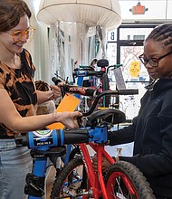 Earning two wheels Richmond Public Schools teamed up with Rag & Bones on Nov. 24 to refurbish up to 50 bikes for students who improve their attendance — with some two-wheelers rolling out to recipients as early as next week. The attendance incentive program targets students in grades K-12, though organizers expect middle and high schoolers to benefit most since they can ride to school on their own. The school district plans to distribute bikes through the spring and again before summer break. Volunteer Stefanie Blake and Brianna Dorsett help get bikes ready for the
road. (photo by Julianne Tripp Hillian/Richmond Free Press)